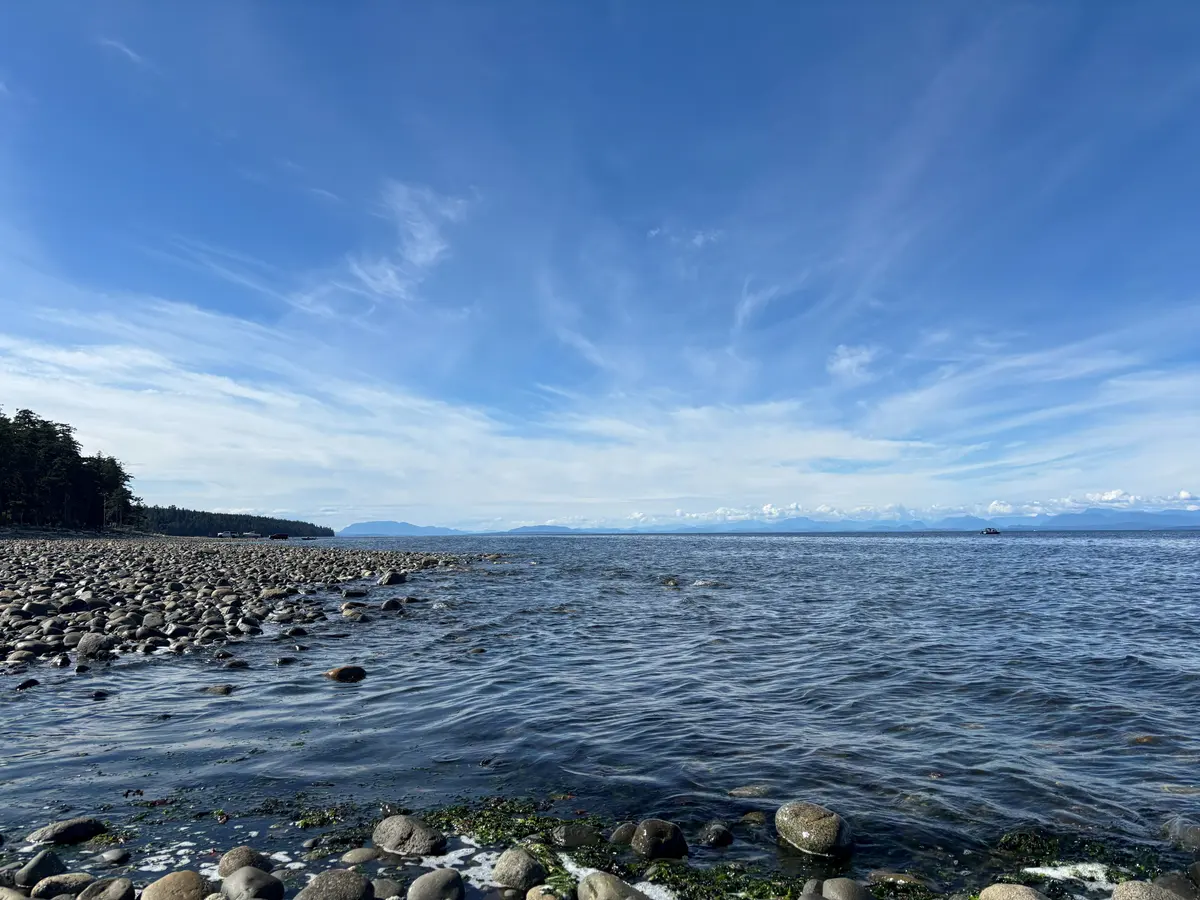 A sweep of wispy cloud over the Strait of Georgia from the Kitty Coleman shore